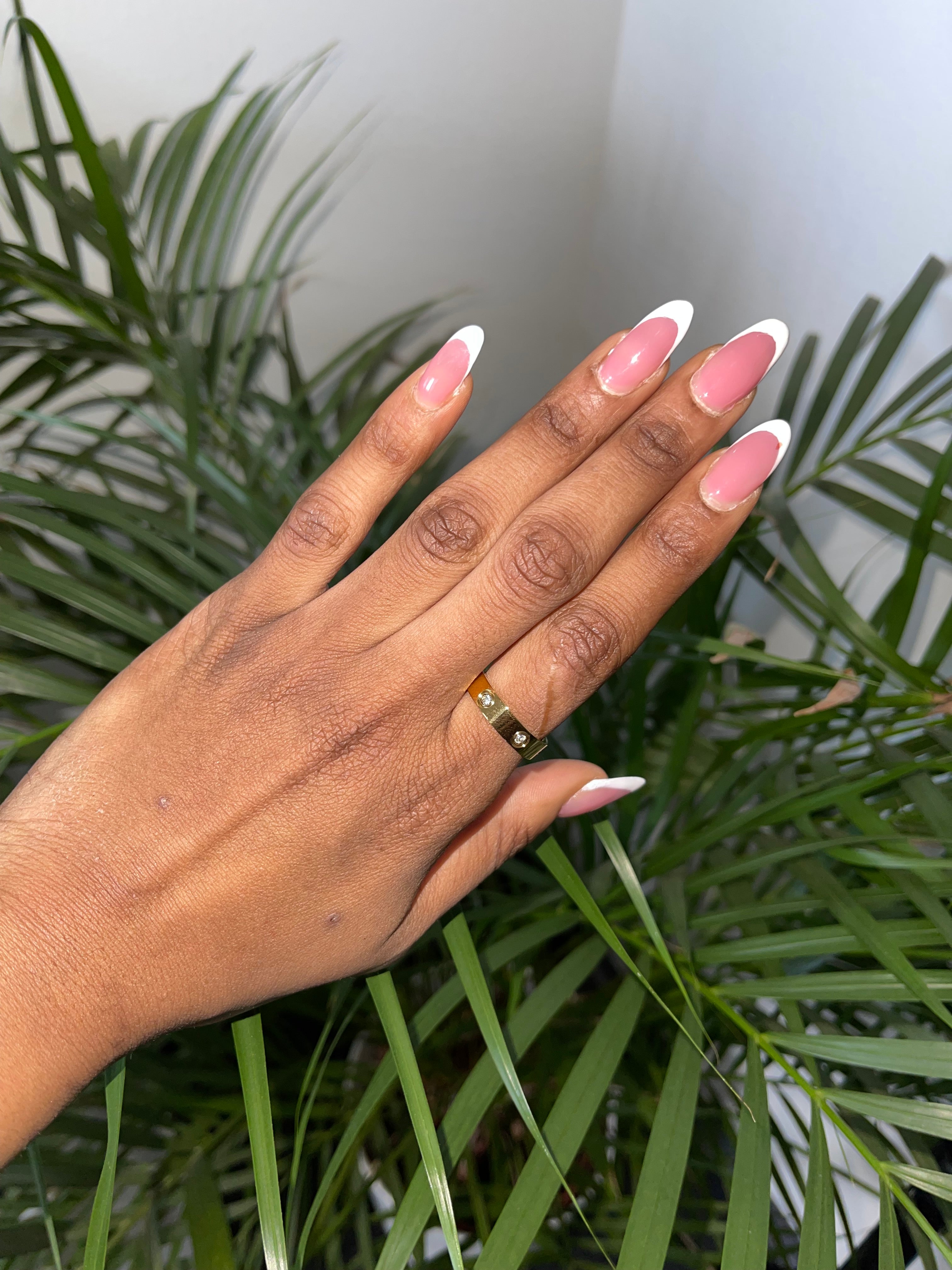 Elegant 18K gold ring on hand, adorned with cubic zirconia stones.