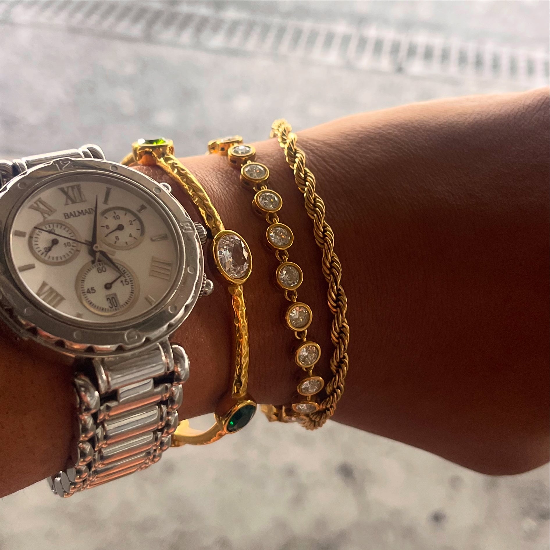 Clarisse Tennis Bracelet with round bezel-set cubic zirconia stones in 18k gold-plated stainless steel, polished gold links, and secure box clasp.