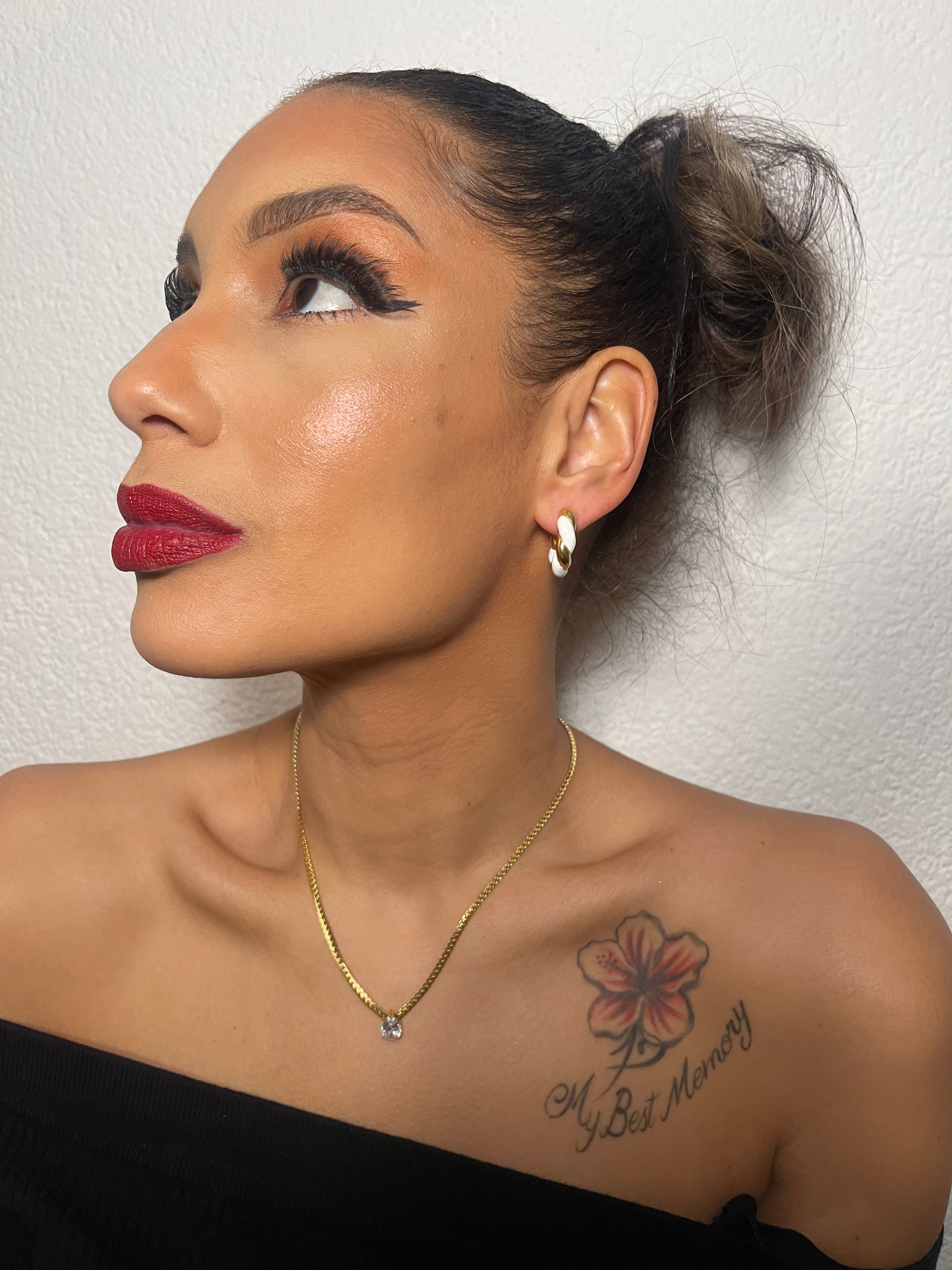 Elegant woman wearing MELISSA gold chain necklace with teardrop pendant.