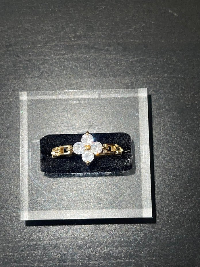 Celia Ring gold plated band with cubic zirconia floral design on black display block