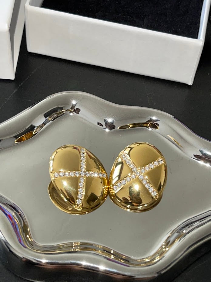 Alexandra Earrings bold gold dome studs with sparkling crystal X detail on silver tray