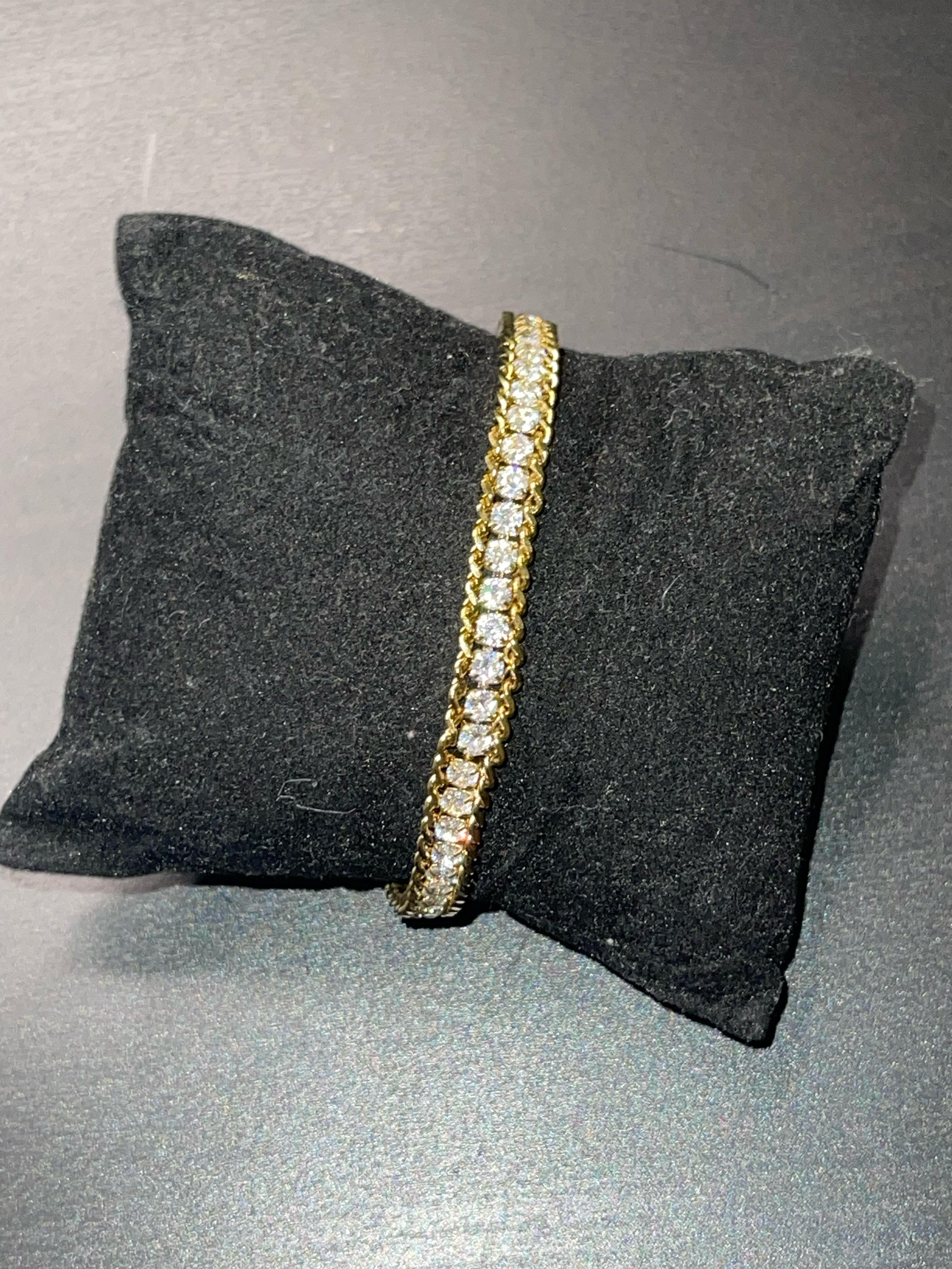 SERENA gold tennis sparkle bracelet with crystals on black cushion.
