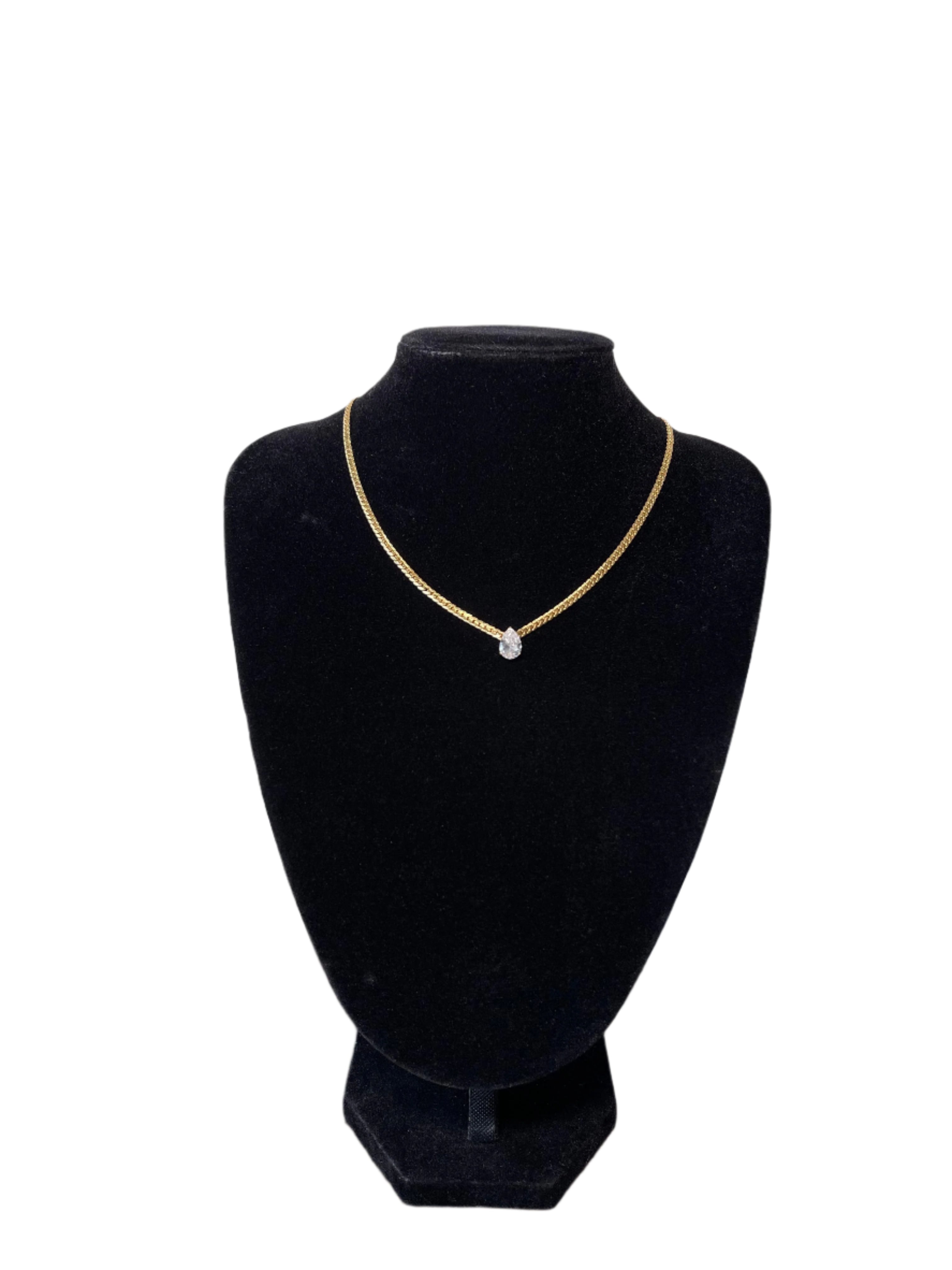 Elegant MELISSA gold chain necklace with teardrop pendant displayed on a black stand.