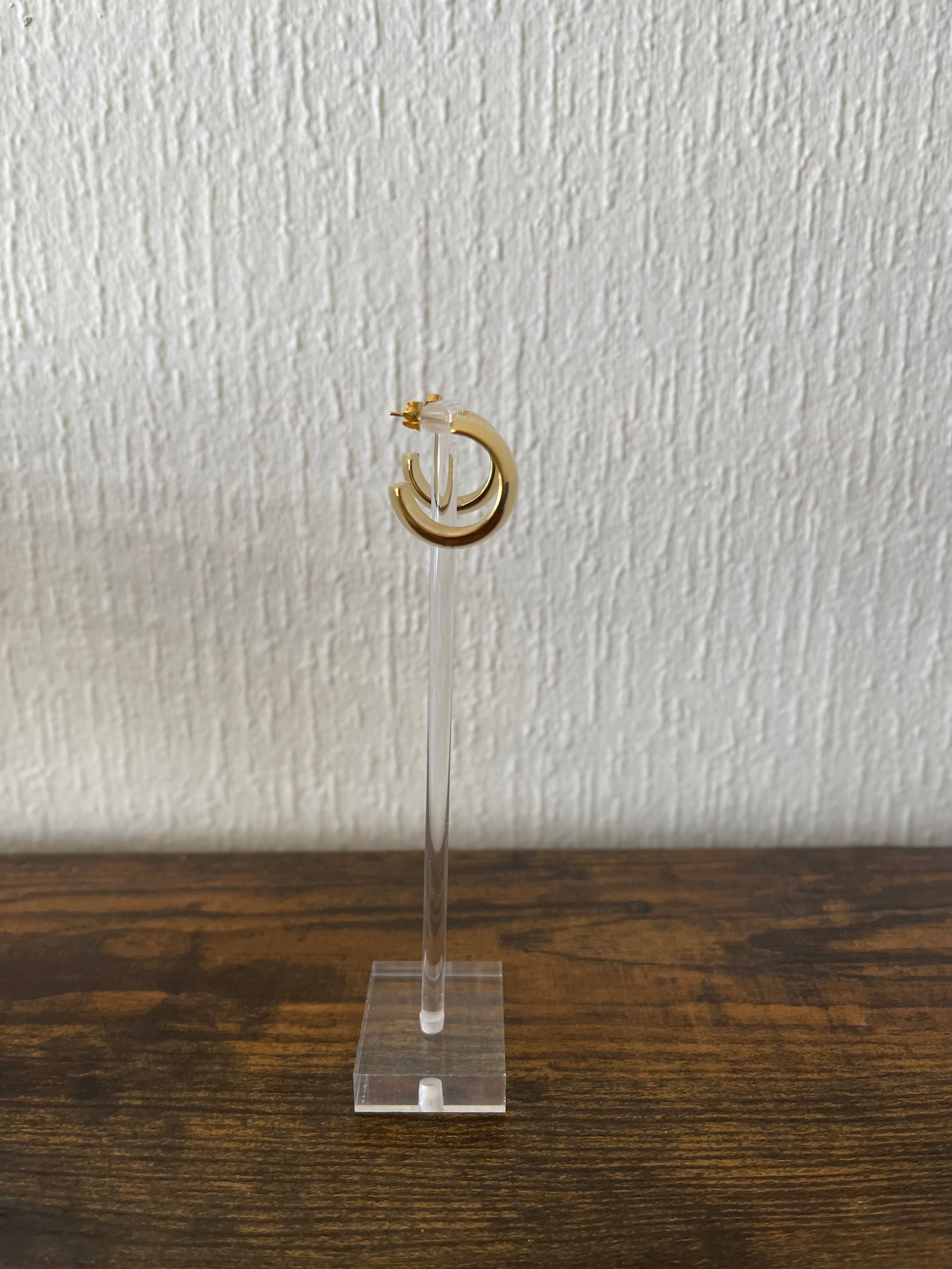 CRISTINA Tiny C-Shaped Hoops in gold on stand, minimalist and sophisticated everyday earrings.