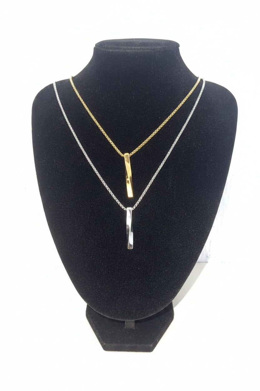 LUCA Necklace minimalist gold and silver stainless steel chains with sleek vertical pendants on black display bust
